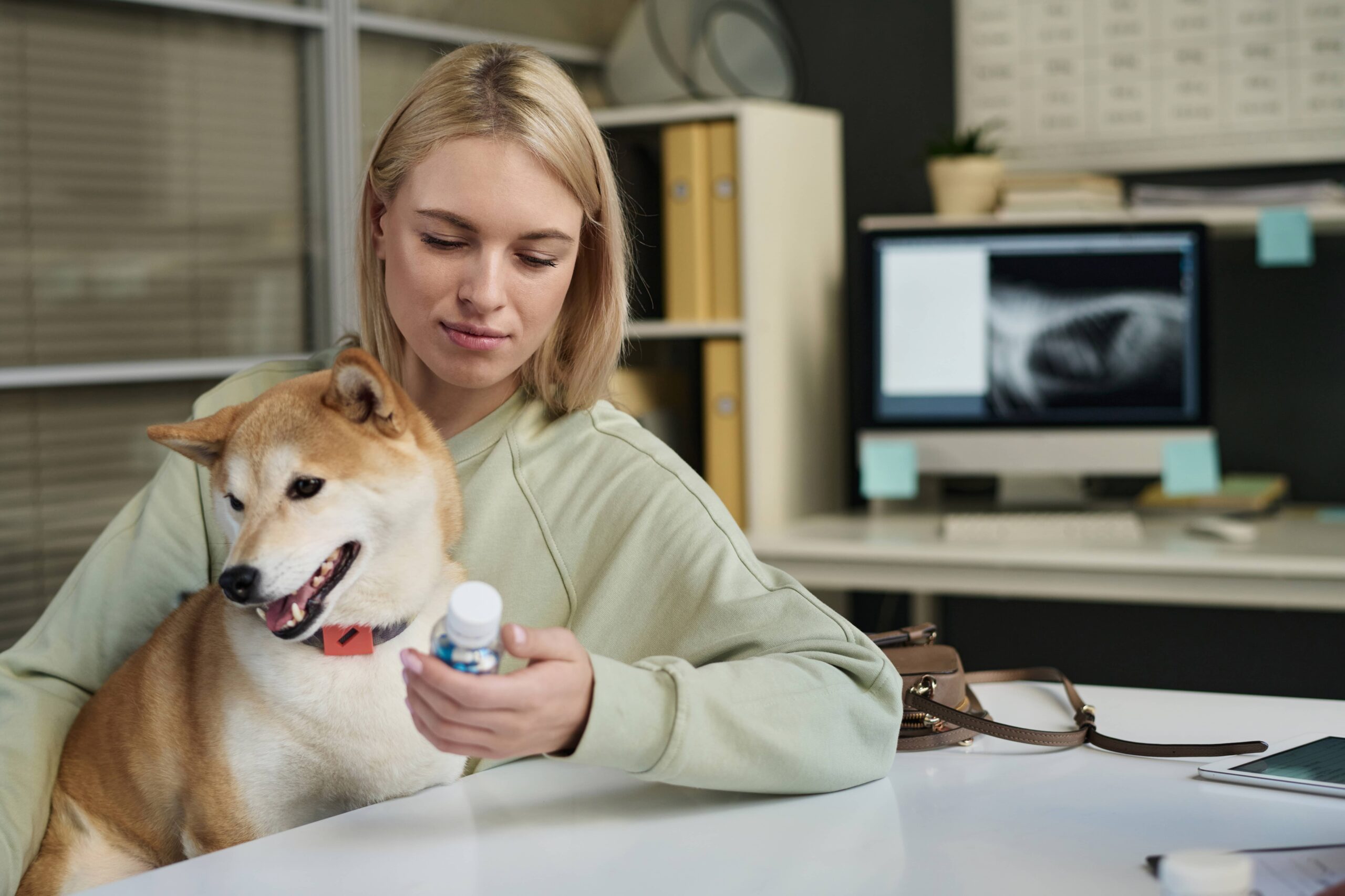 a pet owner with their dog’s prescription